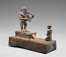 Group statue with a Bes-image plucking a lyre, Cupreous metal