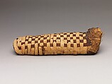 Sacred animal mummy of a canid, Dyed and undyed linen, animal remains, mummification materials