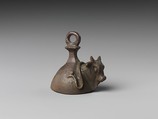 Bell with head of a bovine wearing a yoke ending in uraei, Leaded bronze