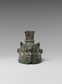 Bell in the form of Bes, cupreous metal