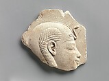 Relief head of a child god, Limestone