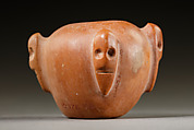 Piriform macehead with male faces, Limestone (pink), organic material