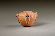 Piriform macehead with male faces, Limestone (pink), organic material