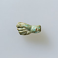 Amulet of fist with thumb thrust between first two fingers, Pale green faience