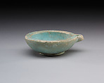 Spouted dish with rosette in the center, traces on the rim where two lions were attached, Faience