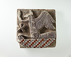 Tile in the form of a rekhyt bird surmounting a neb sign, Faience