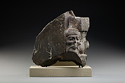 Fragment of a sculptured statue base depicting an Asiatic prisoner, Schist