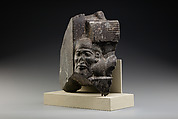 Fragment of a sculptured statue base depicting an Asiatic prisoner, Schist