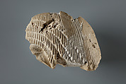 Wig (a) and nemes tail (b), indurated limestone