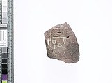 Part of a small block with name of Nefertiti and another on adjacent sides, Red quartzite