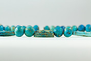 String of  ball beads, cowrie-styled beads, and a scarab, Faience, glazed steatite
