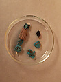 String of 7 amulets, with origianal string on which they were found, Faience, hematite, wood, string