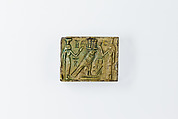 Oblong Plaque Depicting Ramesses II Smiting Enemies, opposite side relief scene of Isis and Nephthys flanking falcon labeled Horus son of Isis, Glazed steatite