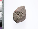 Part of a small block with parts of names of the Aten and Akhenaten preserved on two adjacent sides, Red quartzite