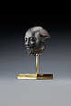 Head fragment from a statuette depicting a "Bald one of Hathor" priest, Steatite