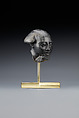 Head fragment from a statuette depicting a "Bald one of Hathor" priest, Steatite