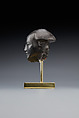 Head fragment from a statuette depicting a "Bald one of Hathor" priest, Steatite