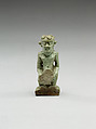 Nude crouching figure wearing a wreath, large phallus broken away, Faience