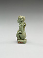 Nude crouching figure wearing a wreath, large phallus broken away, Faience
