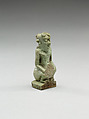 Nude crouching figure wearing a wreath, large phallus broken away, Faience