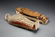 Falcon-form case containing a corn mummy, Painted gessoed wood; mummy: linen, resin, fiber