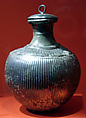 Fluted bottle with ring-handled lid, silver