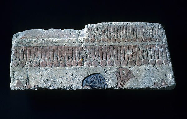 Relief with man carrying papyrus bundle