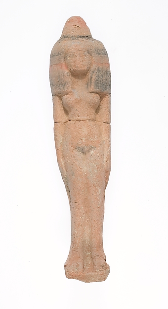 Standing female figurine wearing large headdress and wax cone