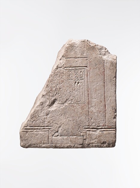 Relief showing part of a temple of Ptah with Haremhab smiting an enemy in front of the god