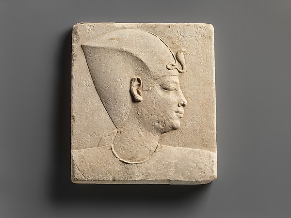 Relief of king's head in blue crown, head of child god on opposite side