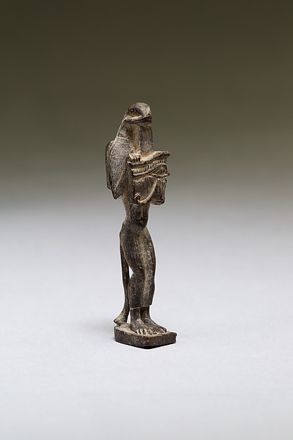 Nehebkau (snake deity) holding a wedjat eye