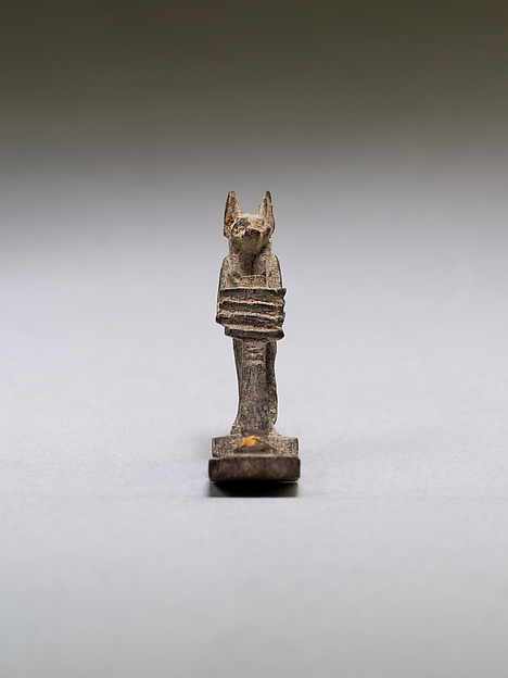 Anubis (?) supporting a large djed pillar