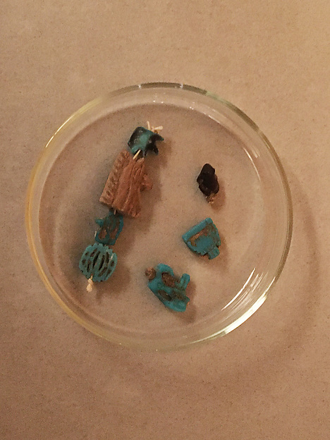 String of 7 amulets, with origianal string on which they were found