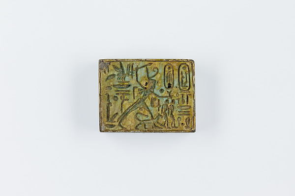 Oblong Plaque Depicting Ramesses II Smiting Enemies, opposite side relief scene of Isis and Nephthys flanking falcon labeled Horus son of Isis