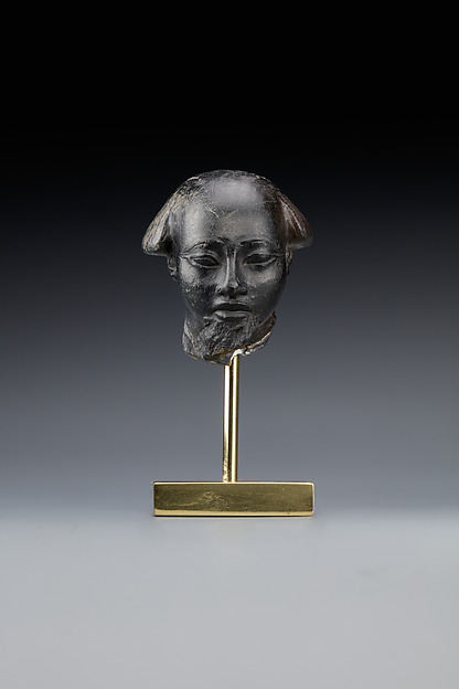 Head fragment from a statuette depicting a "Bald one of Hathor" priest