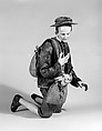 Shepherd with lamb in shoulder bag, Polychromed terracotta head and lamb; wooden limbs; body of wire wrapped in tow; silk, cotton and suede garments; silver metal coiled wire buttons and gold vest, Italian, Naples