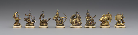 L to R: pawns representing signs of zodiac and phases of moon: 48.174.92i–p Astronomical chess set, Max Esser (German, Barth 1885–1945 Berlin), Silver, silver-gilt, ivory, ebony, marble, plaster, brass, beeswax, enamel, German, Berlin