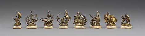 L to R: pawns representing signs of zodiac and phases of moon: 48.174.92i–p Astronomical chess set, Max Esser (German, Barth 1885–1945 Berlin), Silver, silver-gilt, ivory, ebony, marble, plaster, brass, beeswax, enamel, German, Berlin