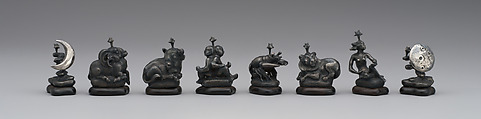 L to R: pawns representing signs of zodiac and phases of moon: 48.174.92ii–pp Astronomical chess set, Max Esser (German, Barth 1885–1945 Berlin), Silver, silver-gilt, ivory, ebony, marble, plaster, brass, beeswax, enamel, German, Berlin