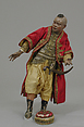 King's attendant, Polychromed terracotta head and wooden limbs; body of wire wrapped in tow; silk and satin garments with silver thread and glass buttons; cotton turban; brass sword, Italian, Naples