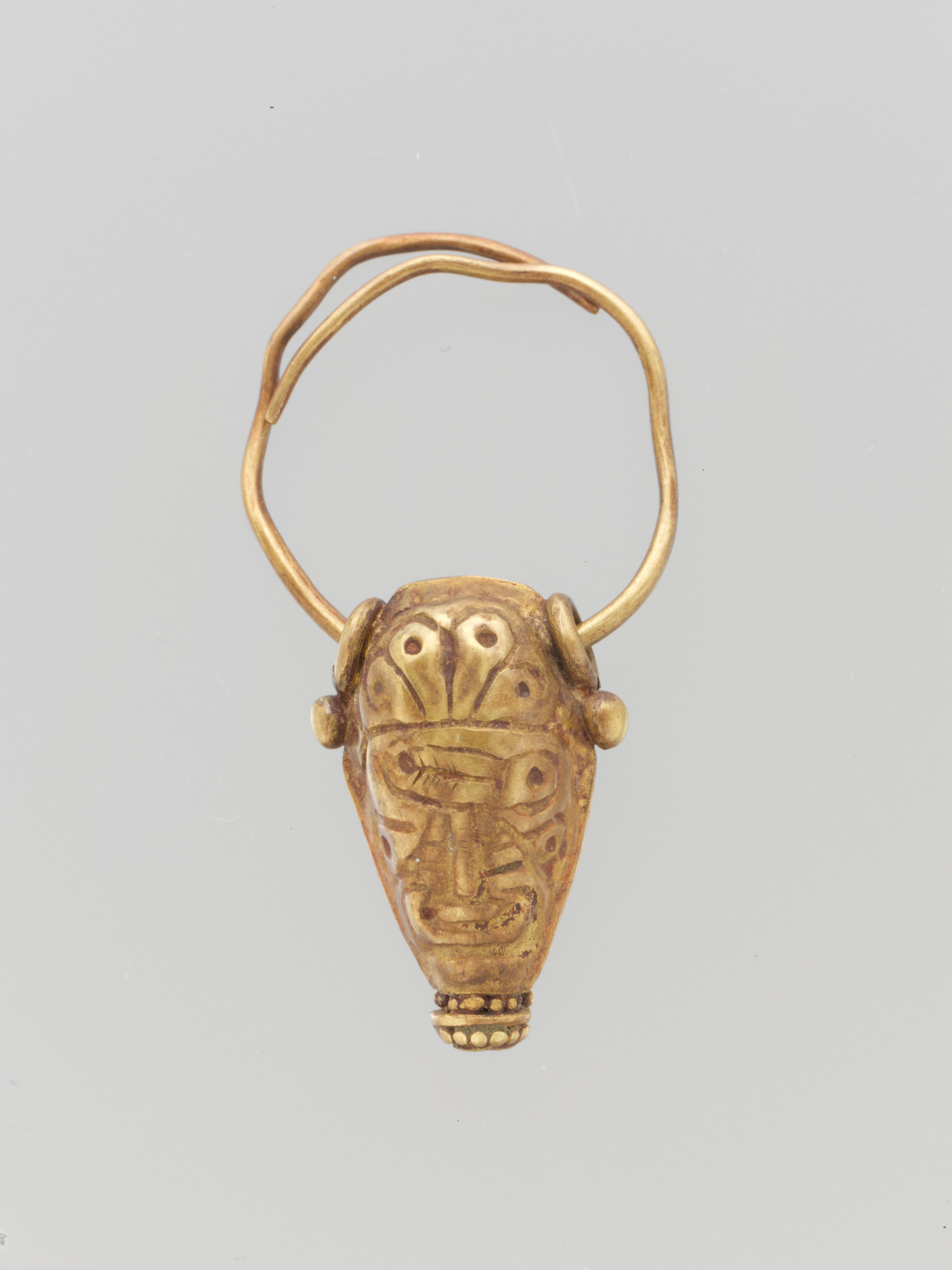 Gold earring with head of bull