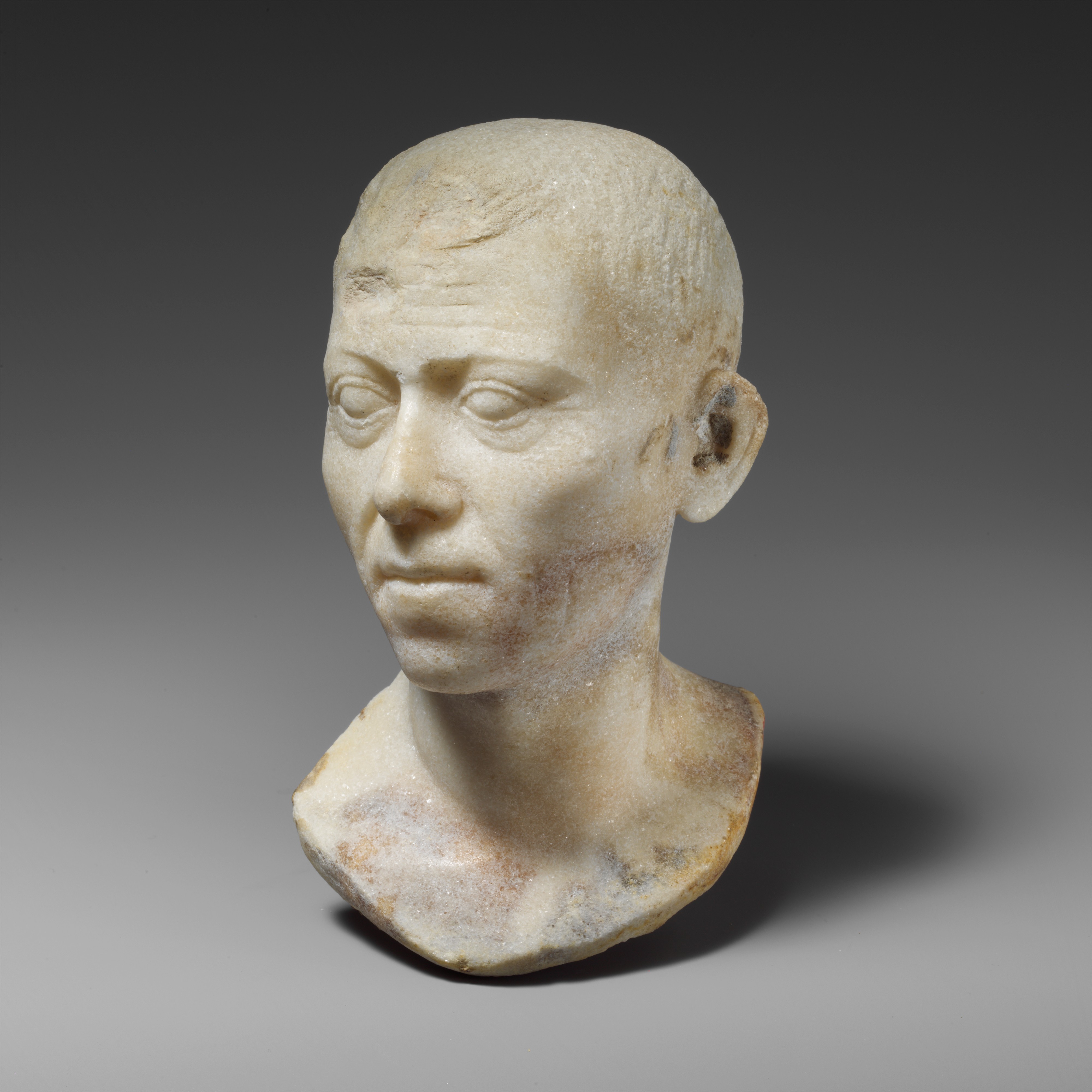 3 / 4 view marble bust of a latino skinny young man