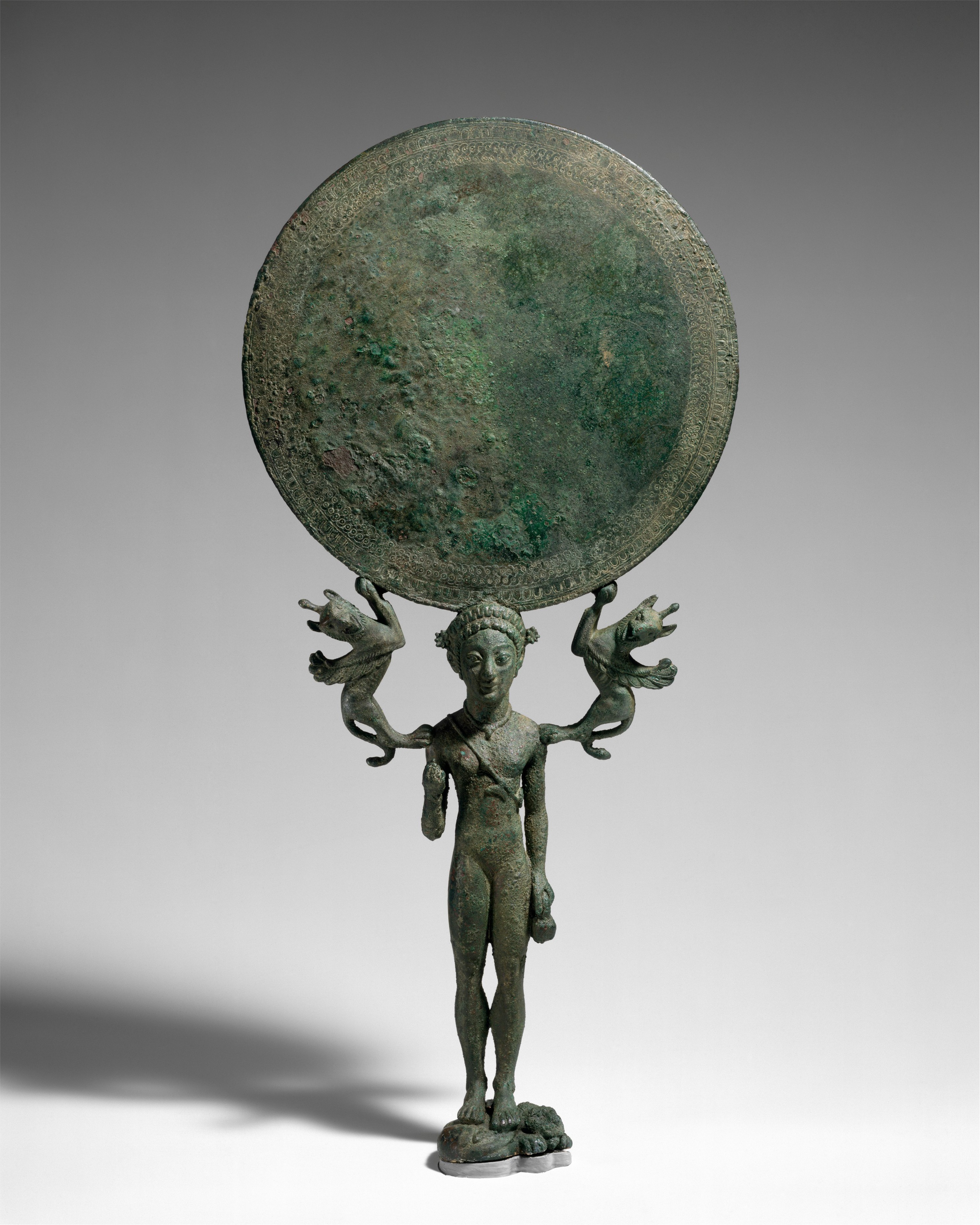 Bronze mirror with a support in the form of a nude girl - Greek, Laconian - Archaic - The ...