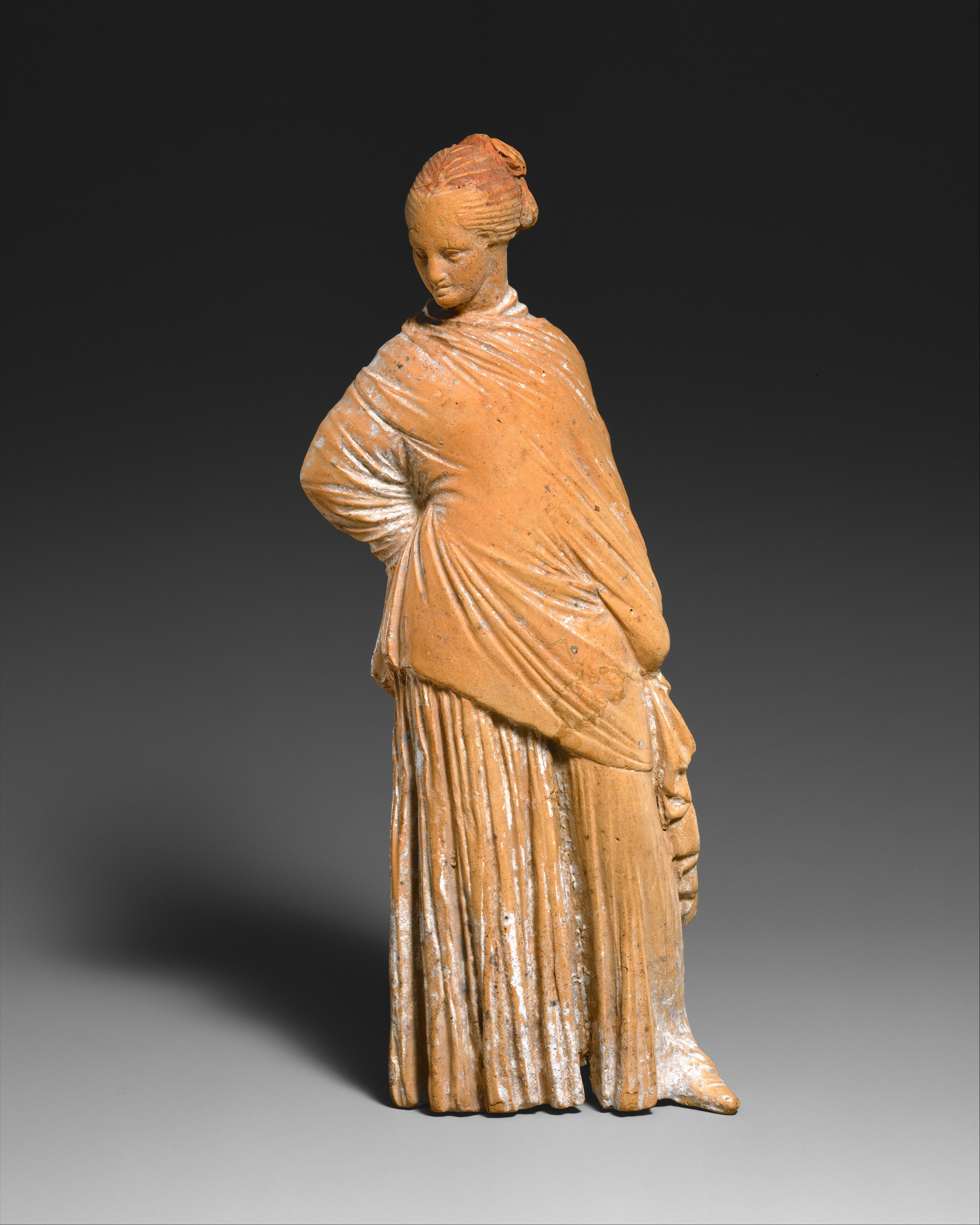 Terracotta statuette of a standing woman | Greek, probably Boeotian