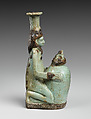 Faience double-spouted vessel in the form of a kneeling woman holding a jar, Faience, East Greek