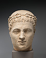 Limestone head of beardless male votary with wreath of leaves, Limestone, Cypriot