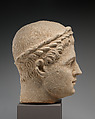 Limestone head of beardless male votary with wreath of leaves, Limestone, Cypriot