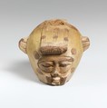 Faience aryballos (oil flask) in the form of a head wearing an animal skin, Faience, East Greek