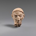 Terracotta head of a man wearing a cap, Terracotta, Greek