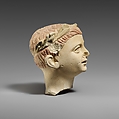 Limestone head of a boy with a wreath of leaves, Limestone, Cypriot